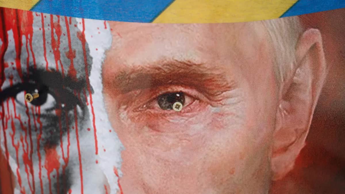 A poster with Russian President Vladimir Putin is displayed during a protest in front of the Russian Embassy in Riga, Latvia, 17 March 2022. Photo: EPA-EFE/TOMS KALNINS