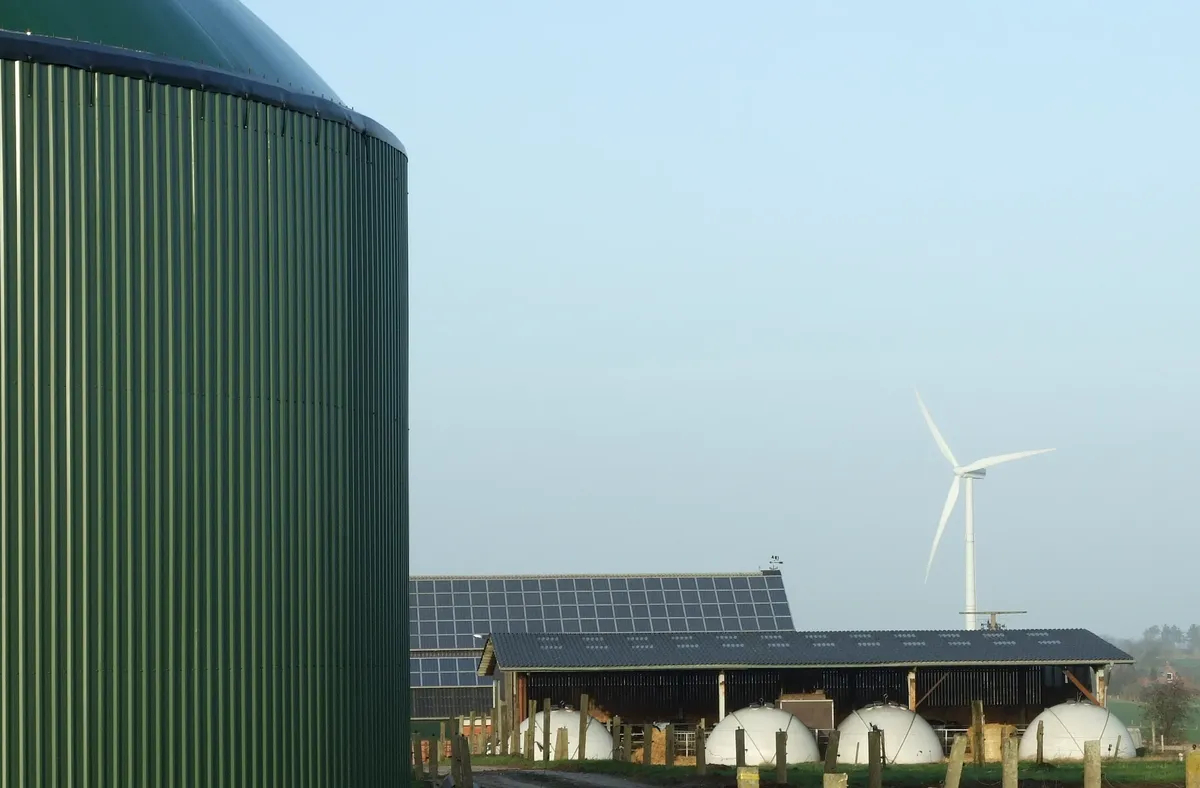 An installation for biogas production, photovoltaic panels, and a wind turbine, Schleswig-Holstein, Germany. Photo: Wikimedia Commons , Florian Gerlach (Nawaro). CC BY-SA 3