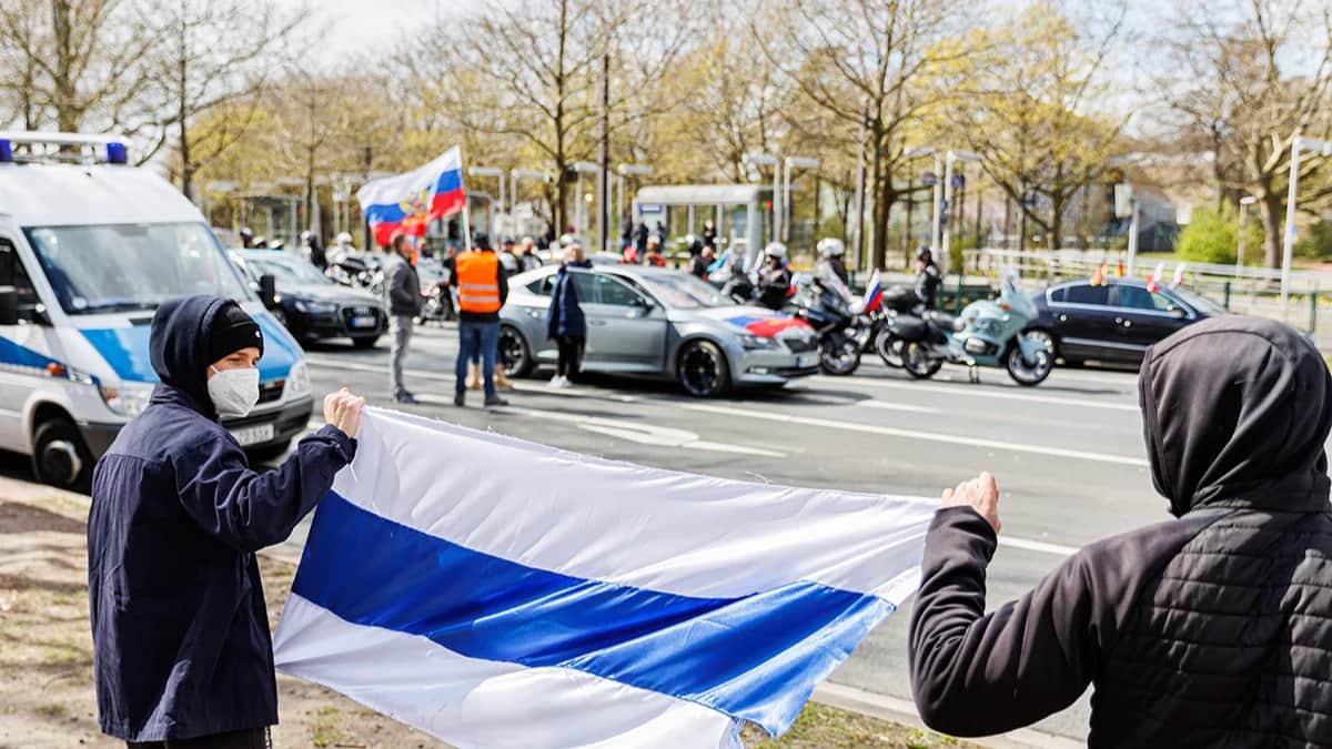 Демонстранты с БСБ-флагом на фоне пророссийского автозабега в Гановере в апреле 2022. Фото: Michael Matthey / picture alliance / Getty Images