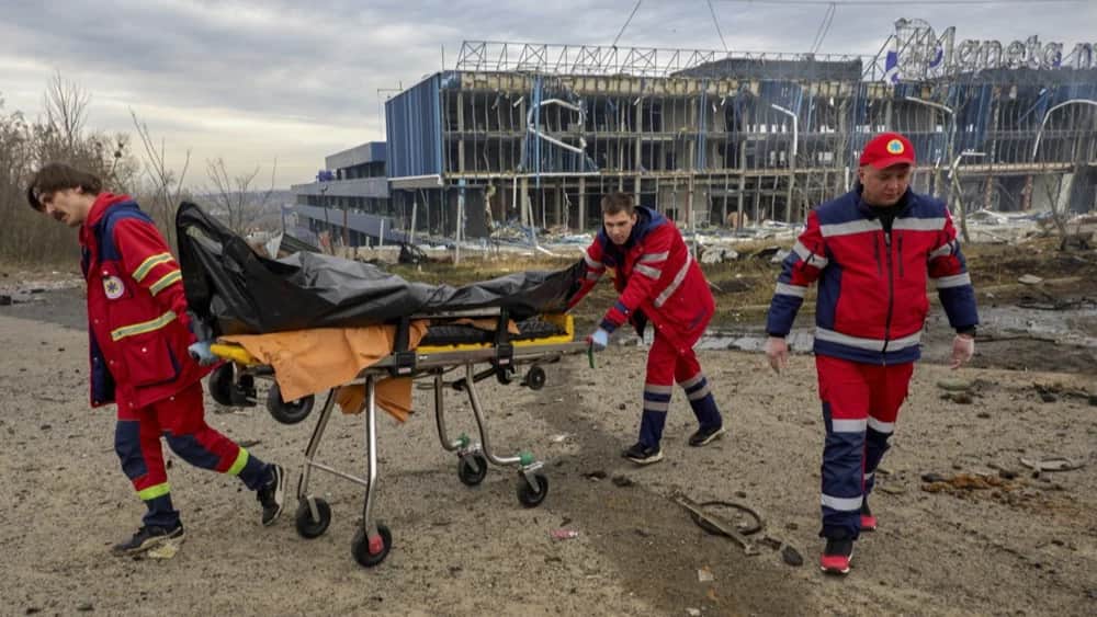 Medical personnel remove a body from the scene of an overnight shelling attack in Kharkiv. Photo: EPA-EFE/SERGEY KOZLOV
