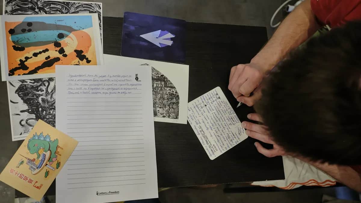 An activist writes a postcard of support during the Letters for Political Prisoners event at Kovcheg’s headquarters in Yerevan, Armenia, June 2024. Photo: Fabio Lovati