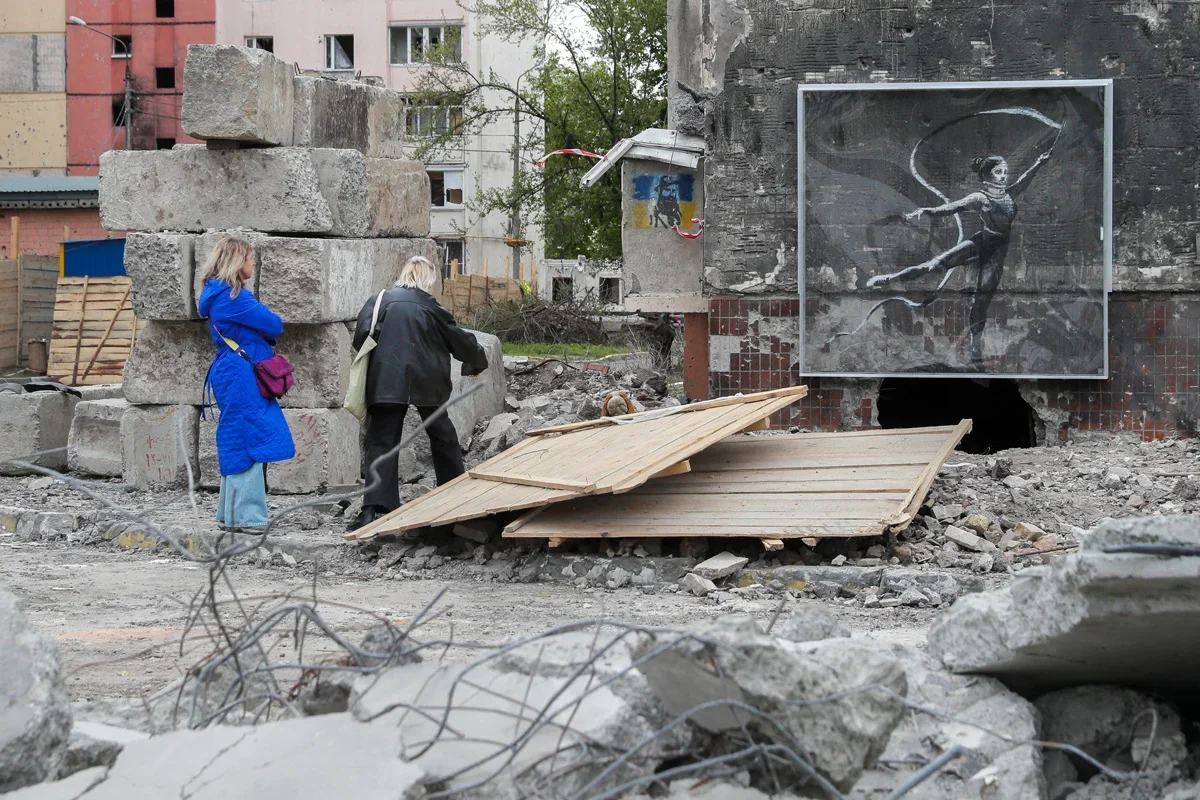 A Banksy artwork on the ruins of a building in Bucha, April 2023. Photo: Sergey Dolzhenko / EPA-EFE