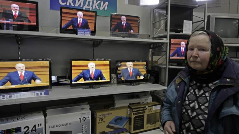 A woman chooses a television set in a shop as Alexander Lukashenko speaks during his annual message to the Belarusian people. Minsk, Belarus, April 2011.