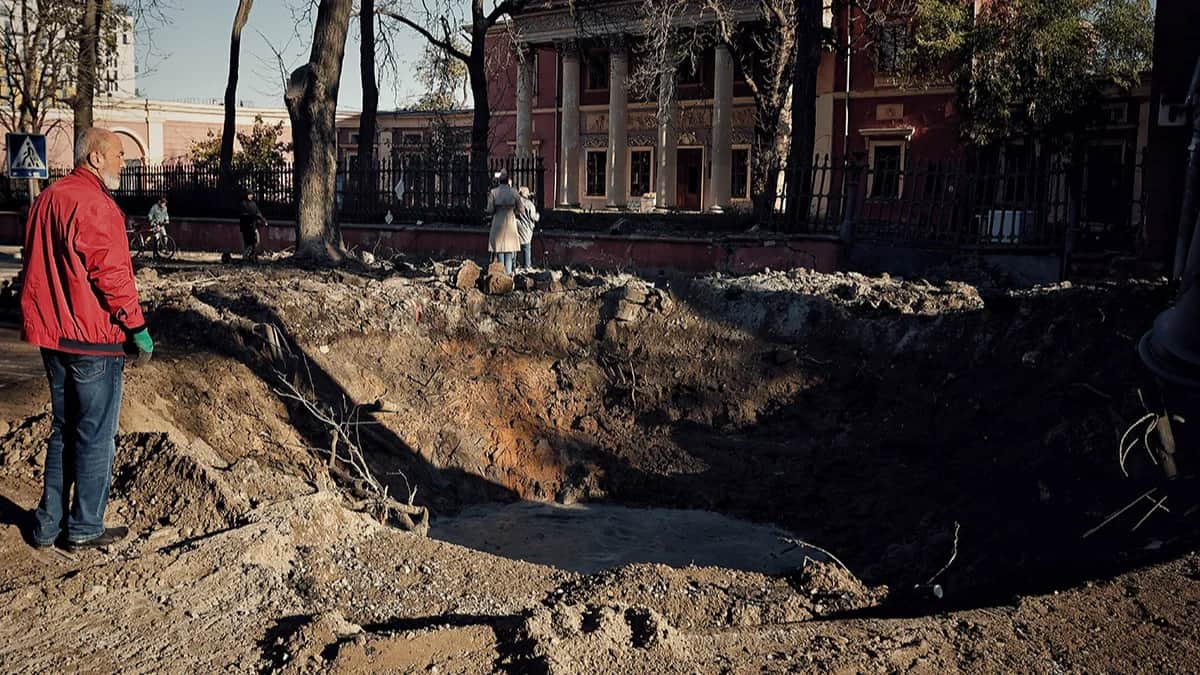 Мужчина стоит возле воронки, оставшейся после атаки российских ракет и беспилотников 6 ноября 2023 г. в Одессе. Фото: Ян Доброносов / Global Images Ukraine / Getty Images