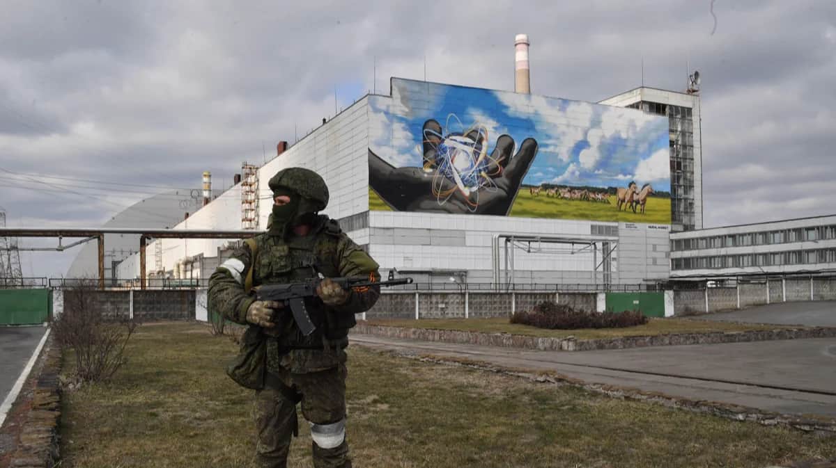 Российский военнослужащий на фоне Чернобыльской АЭС, 24 марта 2022 года. Фото: Picvario Media, LLC / Alamy / Vida Press